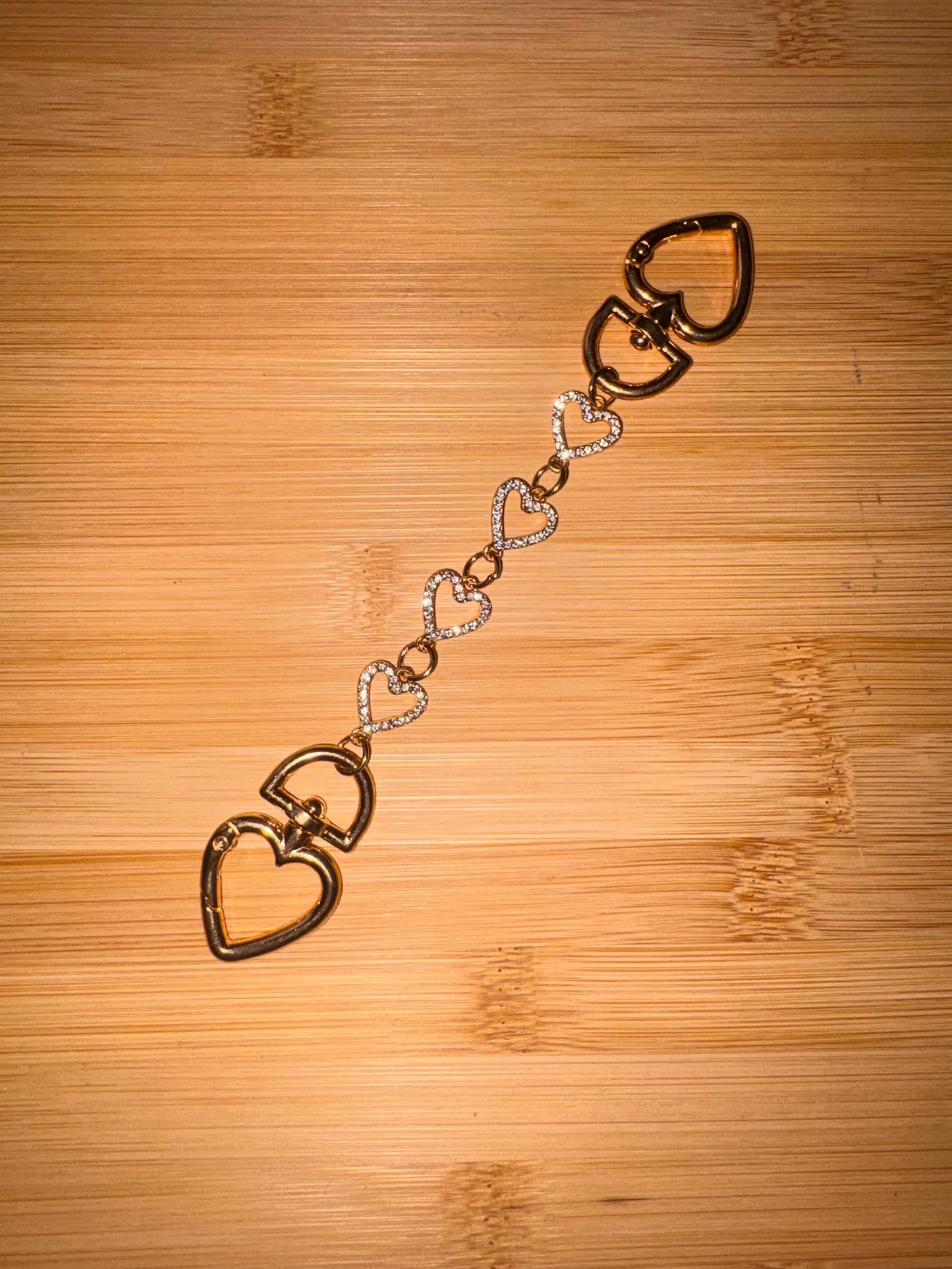 Gold and rhinestone heart shaped purse charm.