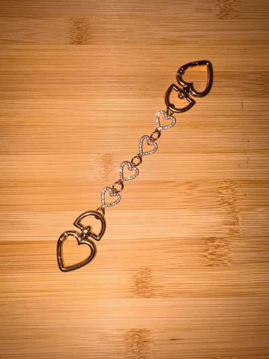 Gold and rhinestone heart shaped purse charm.