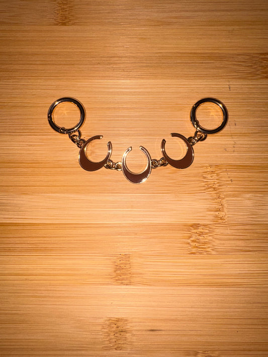 Gold and Brown “C” purse charm.